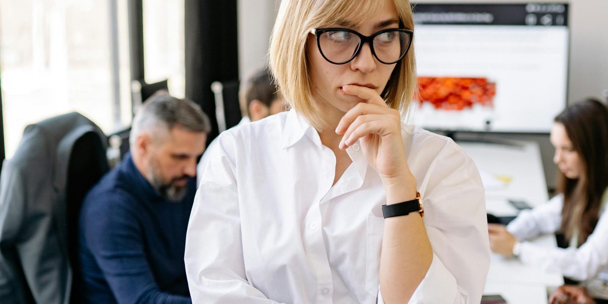 A business owner thoughtfully considering options and making a strategic decision for their company's future.