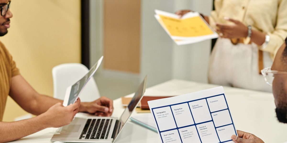 A team of business professionals collaboratively reviewing a complex legal document or financial statement.