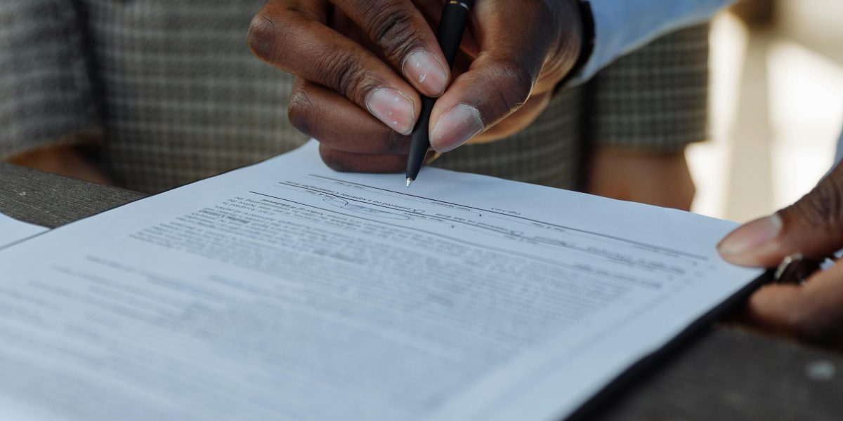 Professionals meticulously reviewing legal contracts to ensure compliance and avoid potential pitfalls.