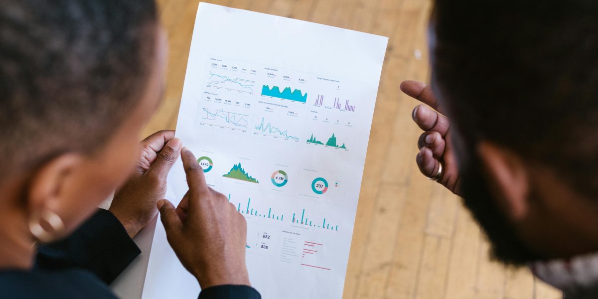 Real estate professionals collaborating to analyze market data and pricing trends.