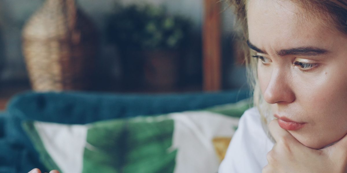 A person carefully considering options, symbolizing the importance of choosing the right real estate broker.