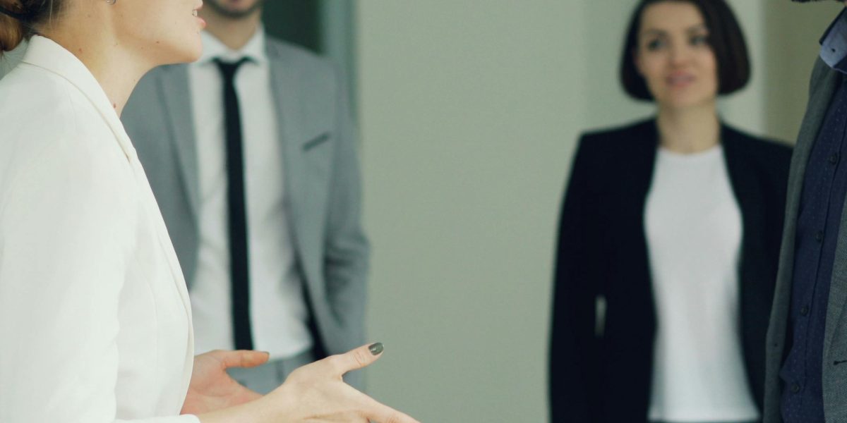 A person engaging in a focused discussion with a real estate professional, vetting their services.