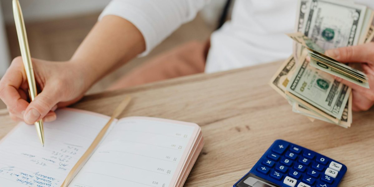 A person carefully analyzing financial documents, representing the act of budgeting for rental costs.