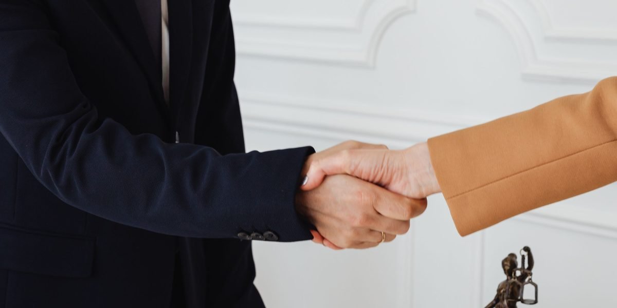 Two professionals shaking hands, symbolizing trust, agreement, and a successful partnership.