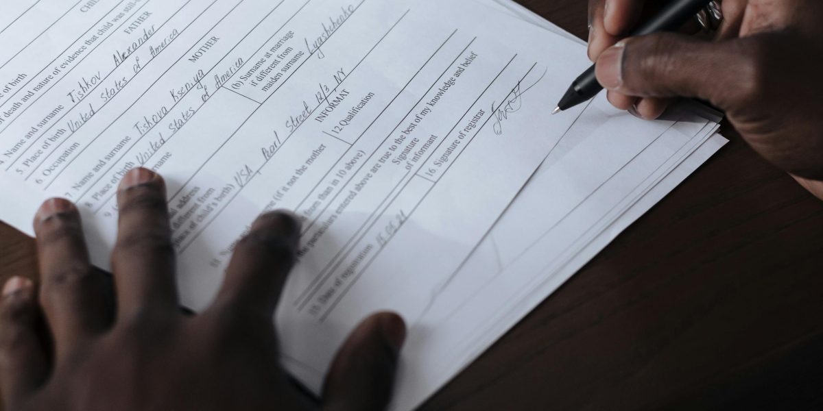 A person carefully reviewing official documents, emphasizing the importance of verifying a broker's legitimacy.