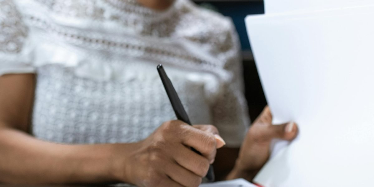 A woman with a confident expression carefully reviewing a legal document, symbolizing a tenant understanding their rights and obligations.