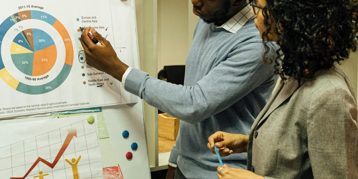 Professionals discussing market trends and opportunities in a collaborative office environment.
