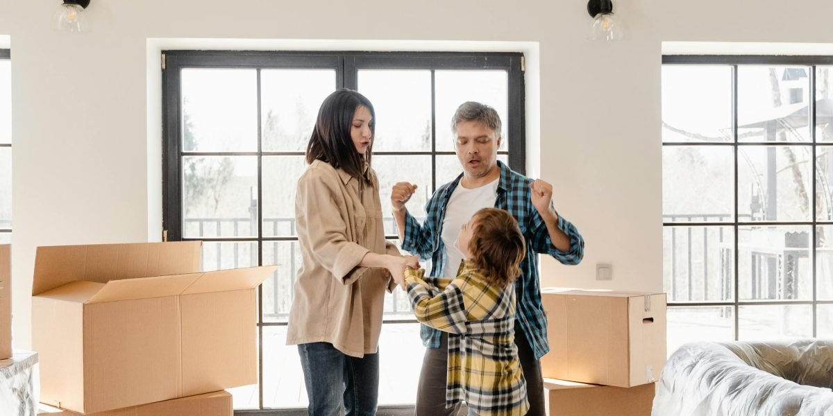A family happily settling into their new apartment, representing the successful outcome of the rental journey.