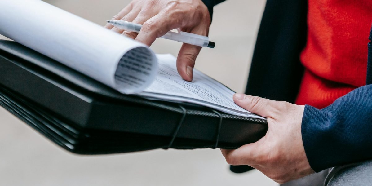 A person carefully reviewing documents, symbolizing the effort to understand complex rental processes.