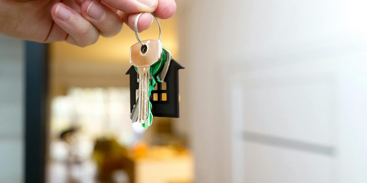 A person receiving keys, symbolizing the successful move-in process for an expat renter.