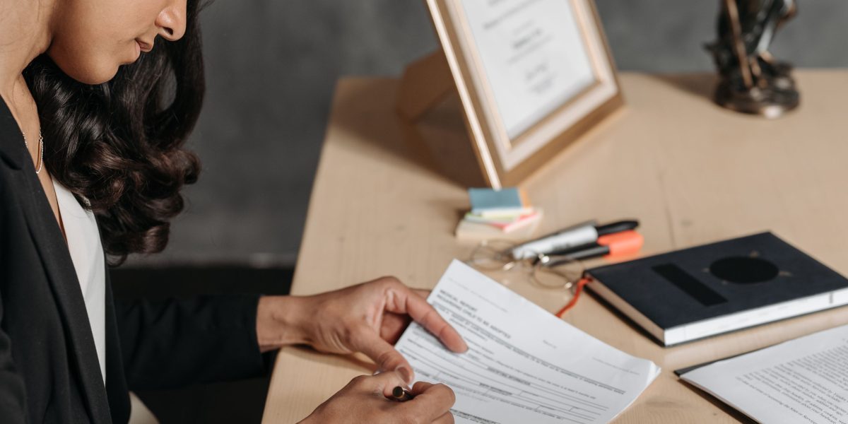 An individual carefully examining the terms and conditions of a rental agreement.